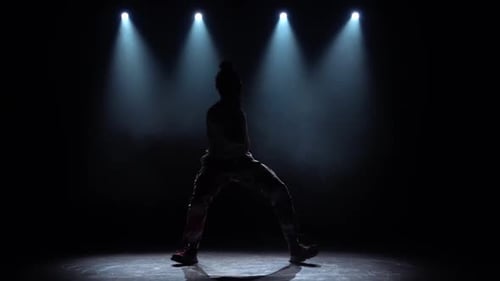 Silhouette Guy Performs Modern Hip Hop Dance on the Dark Studio with Smoke and Lighting, Twisting