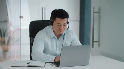 Cheerful Man in Online Business Meeting at Desk