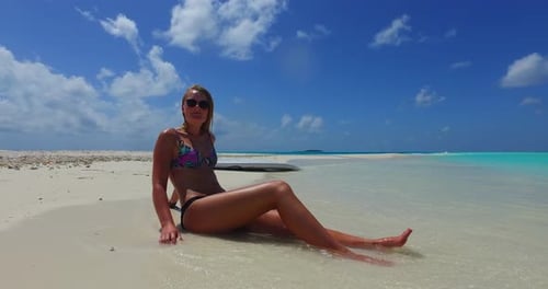 Pretty happy ladies on holiday enjoying life at the beach on summer white sandy and blue background