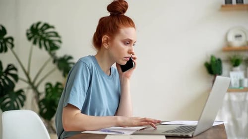 Woman Working From Home on Laptop and Phone