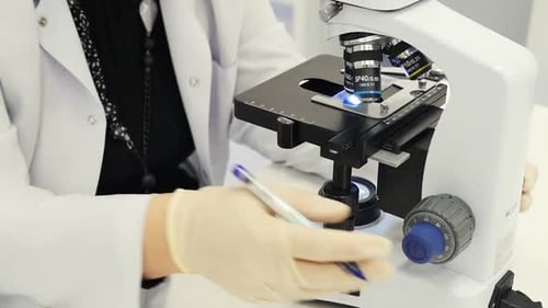 Doctor Working With A Microscope Closeup. Electron Microscope In Action