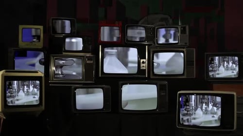 Vintage Television Sets Displaying Static and Factory Footage