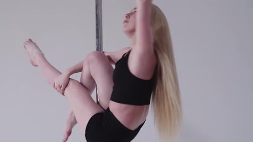 Young Woman Dancing on Pole