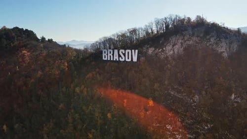 Brasov sign on the top of the hill near the city, yellowed trees, Romania