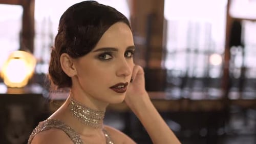 Closeup Portrait of a Young Attractive Woman in a 1920s Style at the Bar