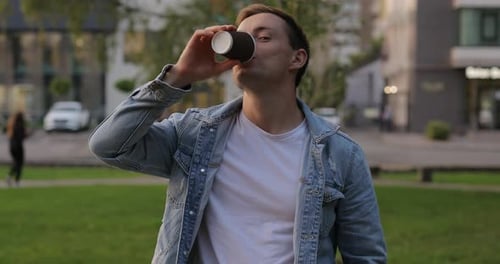 Man Drinking Coffee in City