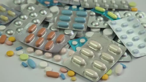 Heap of colorful pills and tablets in blister packs