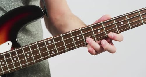 Bass Guitar Being Played by Musician