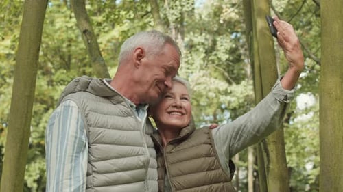 Loving Senior Couple Taking Selfie in Forest
