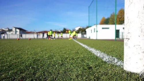 Soccer Goal with Players Practicing in Background