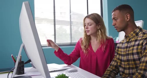 Professionals Collaborating on Project in Bright Office