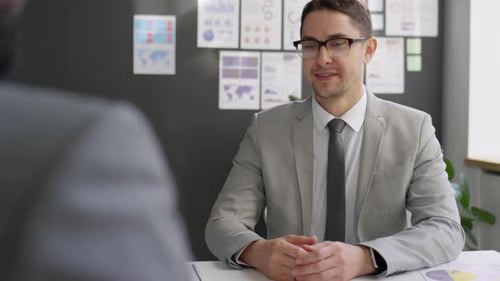 Businessman Shaking Hands and Talking with Colleague at Office Meeting