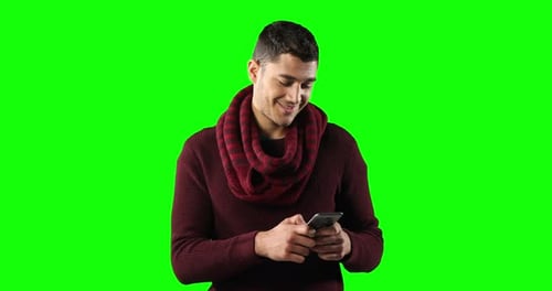 Caucasian man using a smartphone on green background