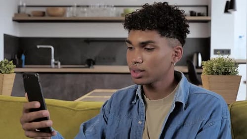 Young Adult Video Chats on Smartphone Indoors