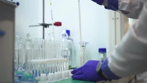 Lab Technician Dispensing Liquid in Laboratory Close Up