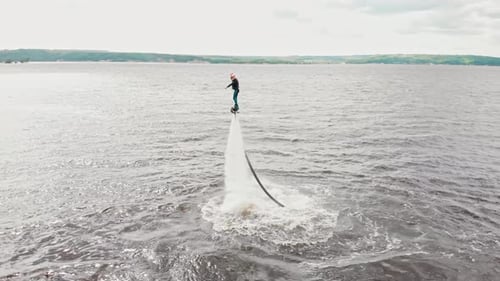 Water Sports a Man Flying Over the Water Aerial View
