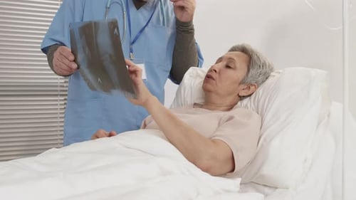 Unrecognizable Male Doctor Showing X-ray Pic to Patient
