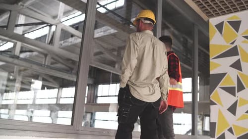Construction Workers Inspecting New Office Building