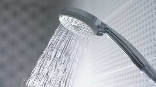 Water Running from Chrome Shower Head Close Up