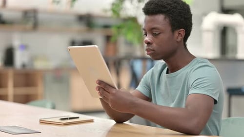 Young Adult Reacts to Content on Tablet