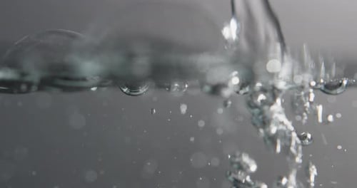 Water Pouring Creates Bubbles and Surface Movement