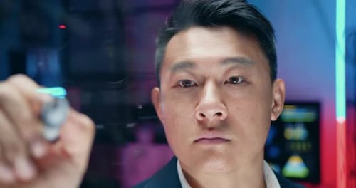 Young Adult Drawing Graphs on Transparent Screen