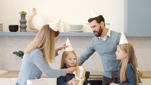 Family Celebrating Child's Birthday Together at Home
