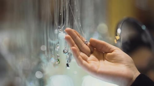 Female Buyer Holding Gem Pendant in Hand, Expensive Jewelry Exhibition, Purchase