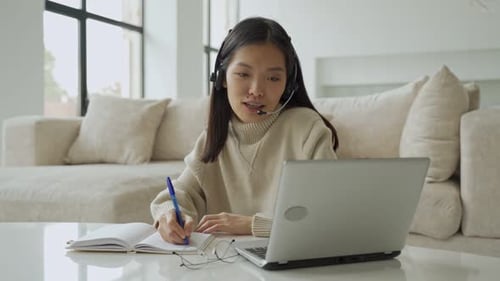 Young Woman Working on Laptop at Home