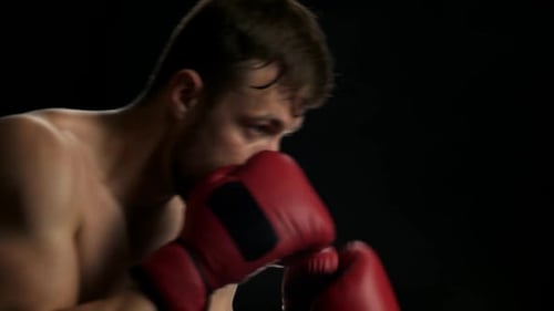 Intense Boxer Throws Punches in Close Up