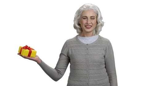 Smiling Senior Woman Holding Birthday Gift