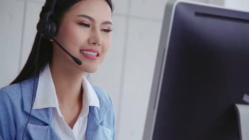 Customer Support Agent or Call Center with Headset Talking to Customer on Phone