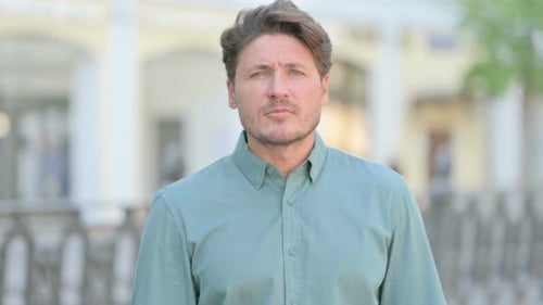 Man Searching Outdoors on City Street