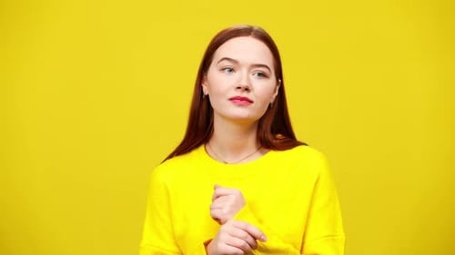 Young Woman Gesturing on Bright Yellow Background