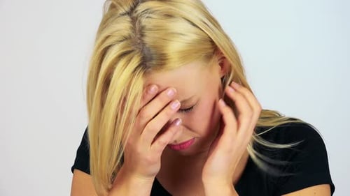 A Young Attractive Woman Cries - Face Closeup - White Screen Studio