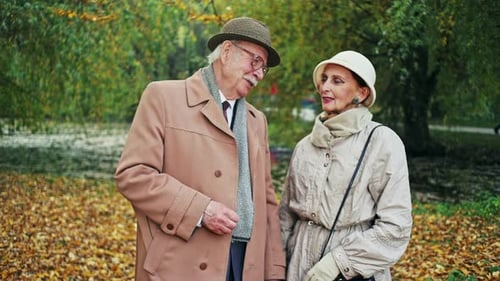 Senior Couple Chatting in Autumn Park Setting