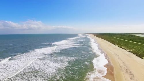 Drone footage on empty beach.