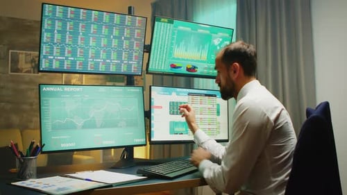 Stock Market Broker Pointing at Monitor Computer