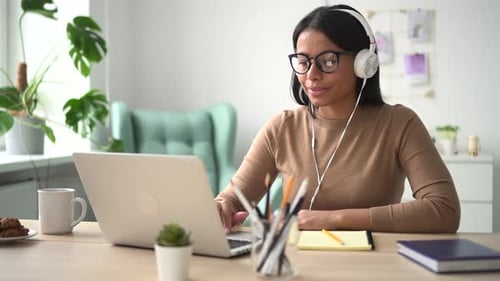 Woman Works at Laptop in Home Office