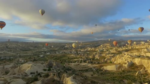 Hot Air Balloons Over Cappadocia's Rugged Landscape