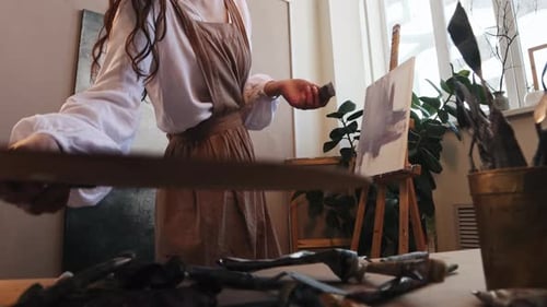 Art Studio Young Woman Artist Drawing a Purple Painting with Oil Paints