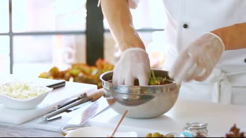 Male Hands Making Salad.