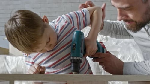 Father Teaching Son to Drive Screws into Furniture