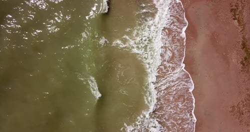 Top Down View of Waves Breaking in the Sand, Flying Over Tropical Sandy Beach and Waves