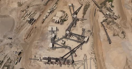 Stone sorting station in a large Quarry, with rocks transported on conveyor belts, Aerial view.