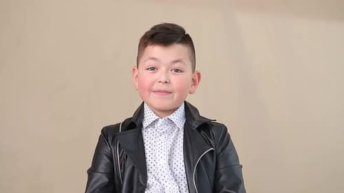 Boy Wearing Leather Jacket Speaks to Camera
