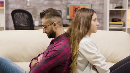 Upset Couple Back to Back on Couch