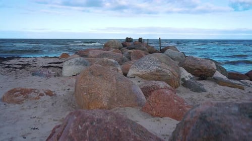 Remains of an Old Pier on Seaport. Rocks and Logs.