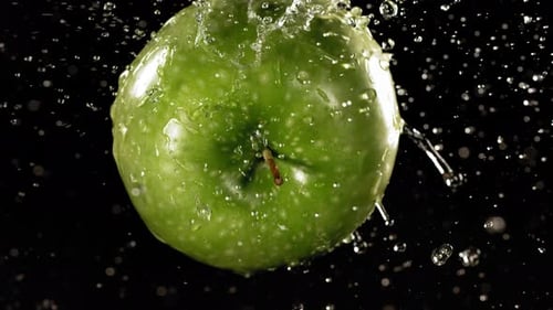Flying of Green Apple in Black Background in Slow Motion