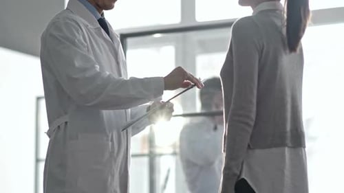 Doctor Explains Medical Information to Woman in Office
